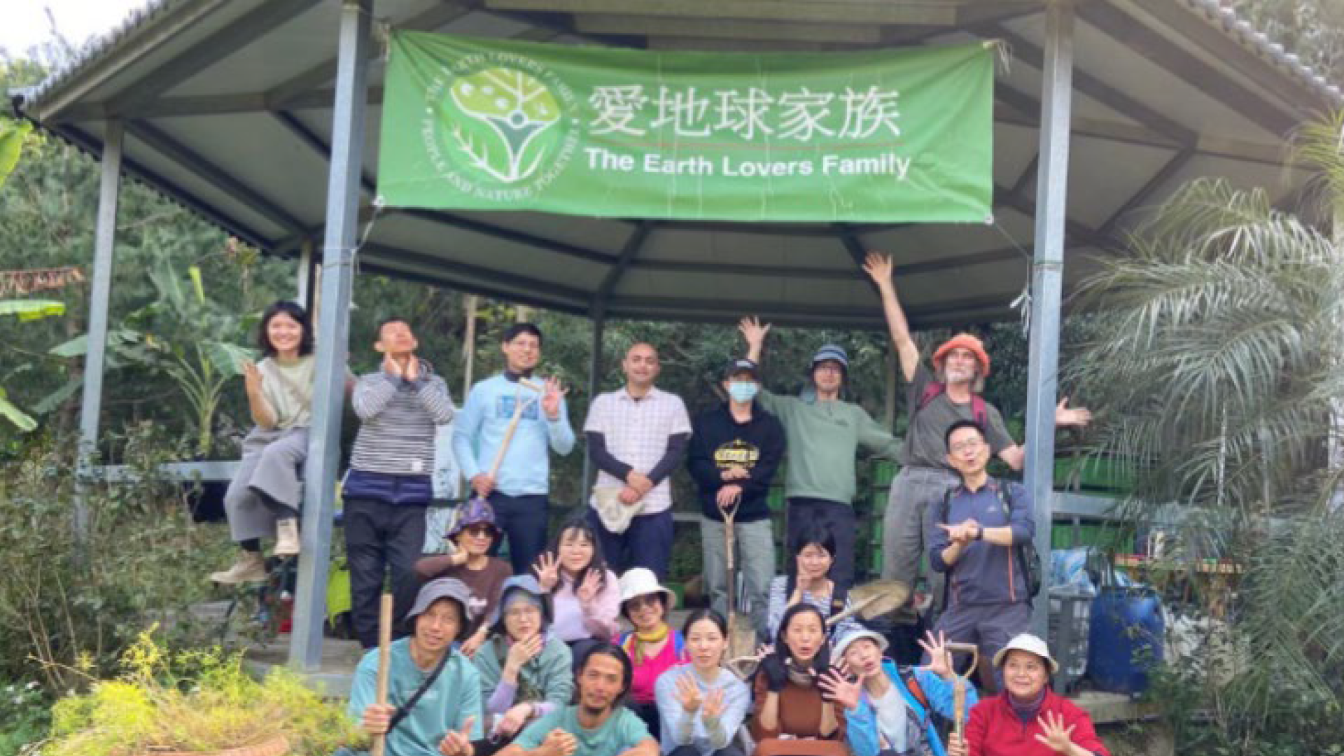 gruppo di persone dell'Asia dell'est sotto un cartello Earth lovers
