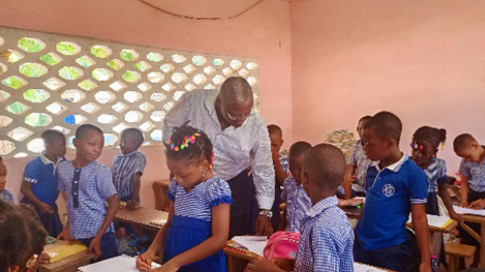 un insegnante tra i banchi di una scuola africana